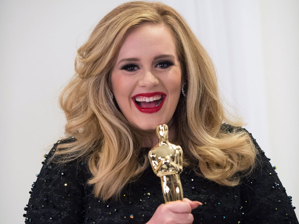 Adele clutching her Oscar for Best Song “Skyfall” in 2012’s